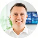 Regional manager portrait in a bright office with a dashboard screen in the background